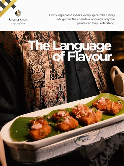 "The Language of Flavour." This branded image showcases our philosophy alongside a plate of crispy appetizers on a banana leaf, emphasizing that every ingredient and spice tells a story.