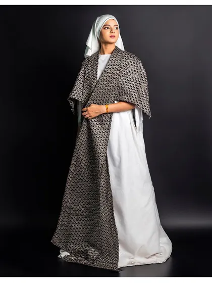 A full-length view of a layered ensemble. We posed the model to display the garment's structure and how it drapes over the body, essential for a designer lookbook.