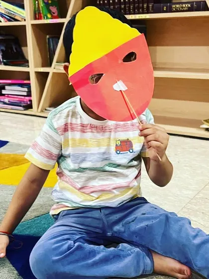A child trying on his finished Ravan mask. We learned fun facts about the story of Ramayana before our craft session.