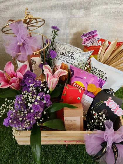 Seal it with a kiss. This "hugs and kisses" themed hamper is packed with munchies and flowers, perfect for celebrating Kiss Day or any day you want to show some love.