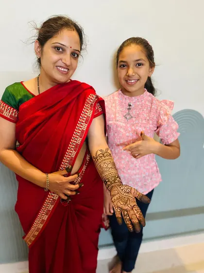 Pointing to her mom's beautifully adorned hand, this student shows the skill and confidence she gained in my class. It's a joy to empower others through this art form.