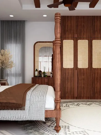 A view of the bedroom showcasing the four-poster bed and the matching wooden wardrobe with rattan panel inserts. The design is a perfect blend of traditional craftsmanship and modern aesthetics.
