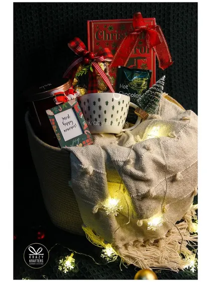 Our 'Snuggle Season' Christmas hamper is all about cozying up with a warm blanket, a good book, and fairy lights.