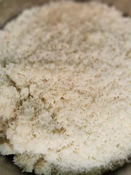 A large bowl of fluffy, perfectly cooked steamed rice, the foundation of any Indian meal.