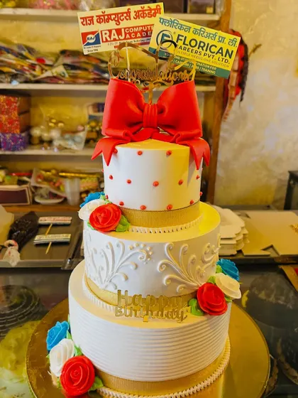 This three-tiered corporate celebration cake features the logos of multiple companies, making it ideal for partnership announcements or large-scale company events. The elegant design with a bold red bow makes a strong statement.