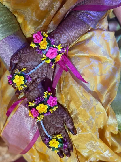 A bride's hands adorned with my henna and beautiful floral jewelry.