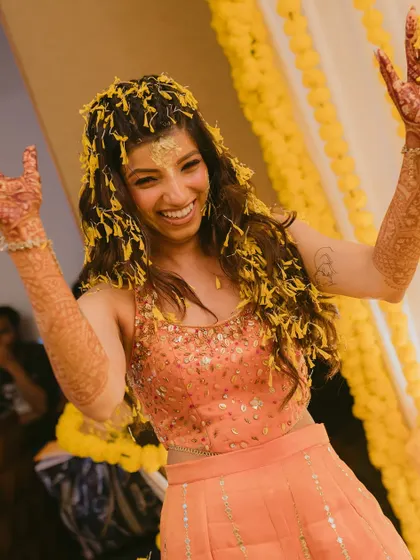 Pure joy! Harshita celebrating during her haldi. Her natural makeup lets her happiness shine through, with just a hint of color on the eyes.