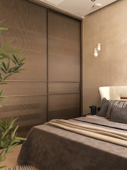 Details matter in creating a sanctuary. The way light filters through sheer curtains, the texture of a fluted wardrobe, and the addition of a simple plant all contribute to a feeling of quiet luxury and calm.