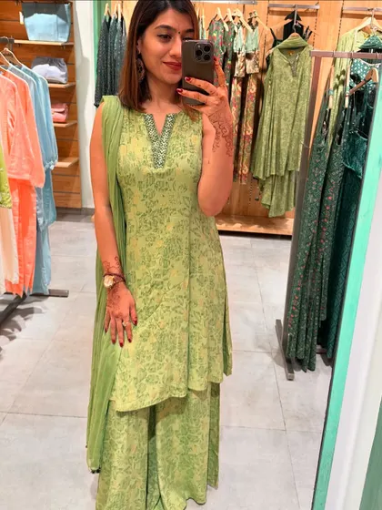 This layered light green sharara set is a fresh and elegant choice for a daytime festive event. The delicate print and silhouette are both flattering and stylish.