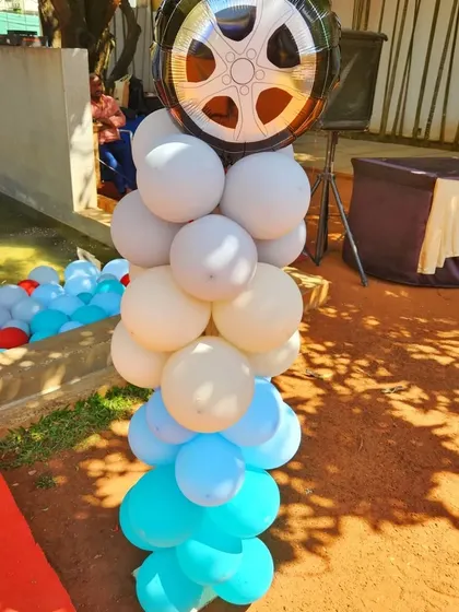 Even small details like this wheel-themed foil balloon on a balloon column help tie the entire party theme together.