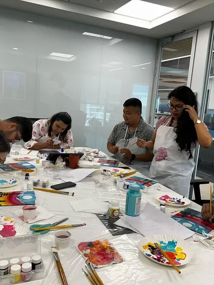 A group from the G2 team enjoying their puzzle painting session. It's a unique way to foster creativity and teamwork.