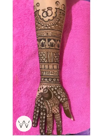 A single arm view of an intricate engagement design, highlighting the beautiful peacock and the engagement ring motif at the top.