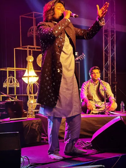 A photo capturing me in a moment of performance, paired with a poignant verse about paths crossing. The image and the words together evoke the feeling of a soulful journey.