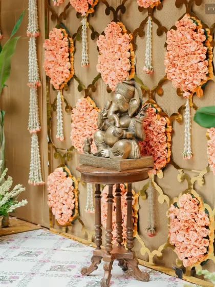 For this Tamil wedding, we created a vibrant floral backdrop using traditional patterns and colors. The Ganesha idol stands as a centerpiece, blessing the union in a space that feels both sacred and full of life.