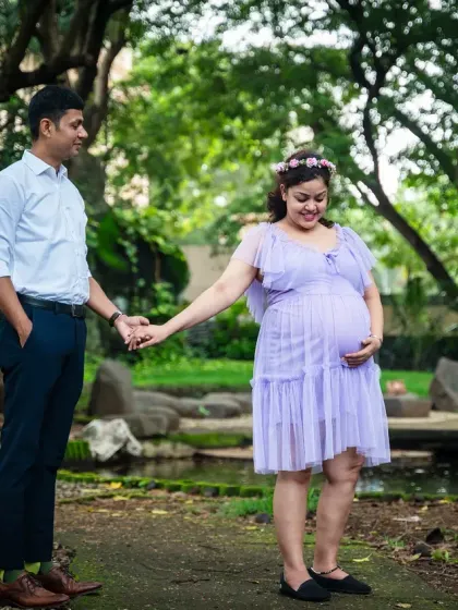 A full-length shot of this lovely couple during their outdoor maternity session. The soft lavender dress and the natural, relaxed pose showcase their gentle connection as they wait for their little one.