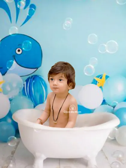 An under-the-sea adventure in our studio tub. The whale backdrop and floating bubbles add a touch of playful imagination to this splash session.