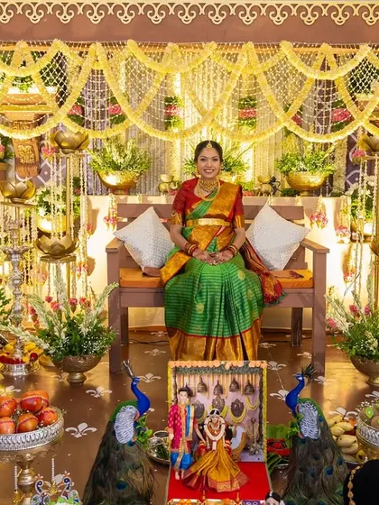 The mother-to-be seated in the heart of the beautiful, traditional baby shower decor we created for her special day.