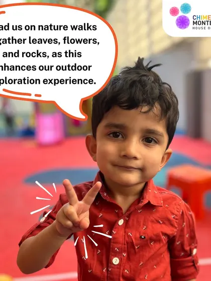 A child gives a peace sign, suggesting a nature walk to gather leaves and flowers. Outdoor exploration is a key part of our curriculum.