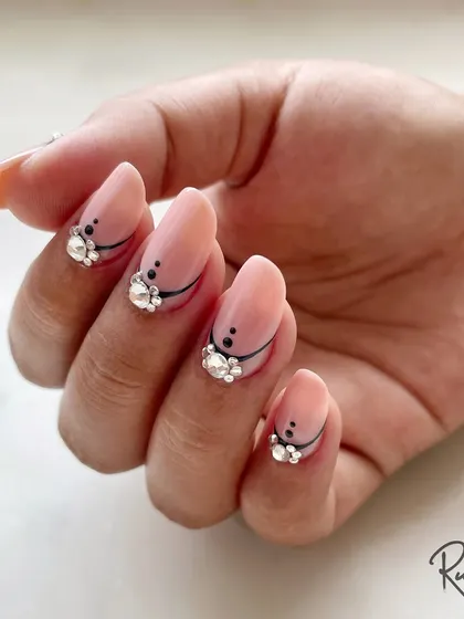 A full hand view of this elegant and modern design. The combination of clean lines and sparkling crystals on a neutral base is perfect for someone who loves sophisticated nail art.