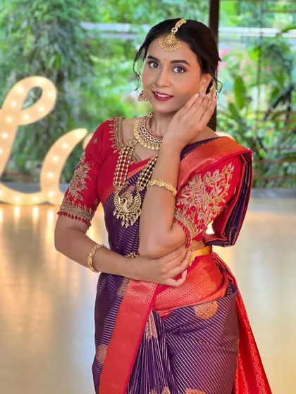 A candid, happy shot of the bride, showcasing the full necklace set and matching earrings.