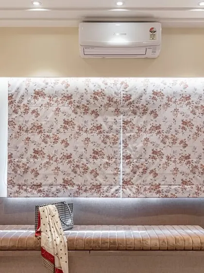 A close-up of the window seat, which offers extra seating and hidden storage. The floral patterned blinds add a decorative touch while providing privacy and light control.