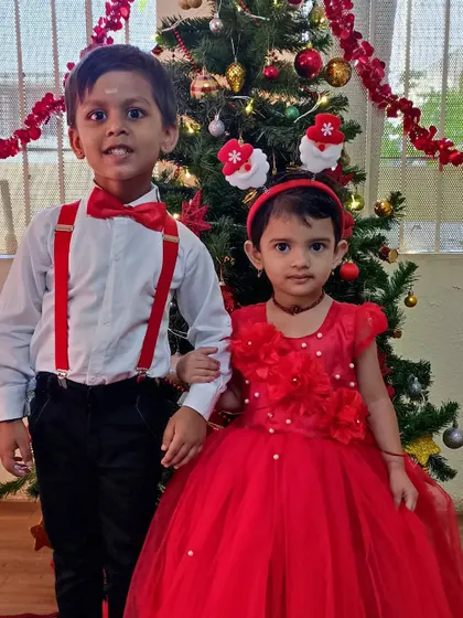 Children dressed in festive red and white for our Christmas party. We celebrate diverse festivals to teach children about different cultures and traditions in a joyful way.