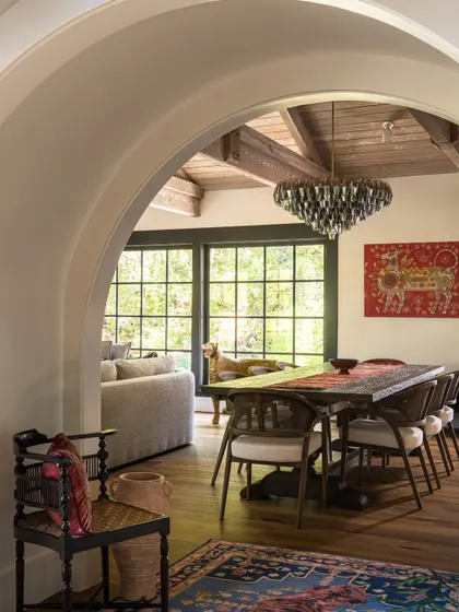 A framed view through an archway into the dining room of the Saratoga residence. This shot emphasizes the home's beautiful architectural bones and the seamless flow between spaces.