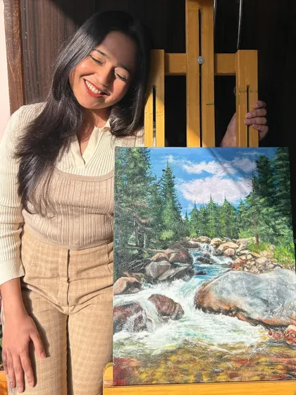A happy moment with my completed oil painting of a flowing river.