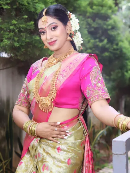 A full-length pose showing the grace and elegance of the South Indian bridal attire, perfectly complemented by the makeup.