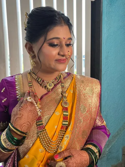 A candid moment showing the bride's complete look, from the intricate jewellery to the perfectly draped saree.