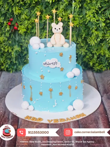 A starry two-tier teddy bear cake for Vedansh's birthday. The gentle blue colour and golden stars create a peaceful, dreamy look.