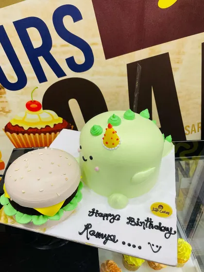 A different view of the creative 3kg hamburger and dinosaur cake combination.