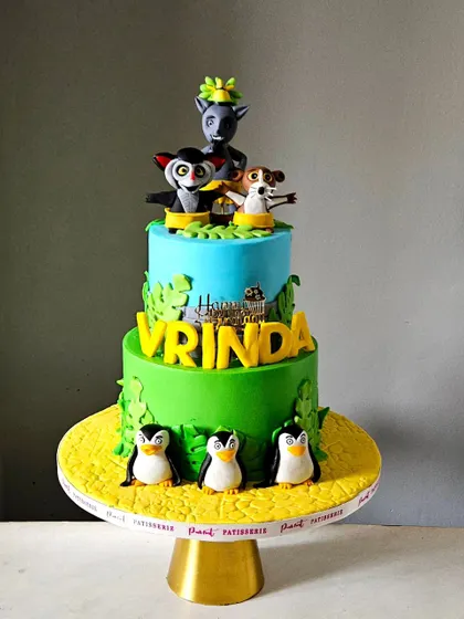 "I like to move it, move it!" This vibrant Madagascar-themed cake features King Julien, Mort, and Maurice, along with the hilarious penguins. All characters are handcrafted from fondant for a fun and lively birthday party.