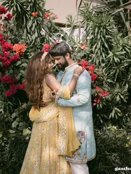 A romantic portrait of the couple amidst a backdrop of vibrant bougainvillea during their destination wedding in Bali.