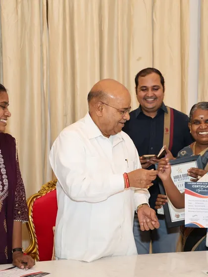 The smiles on everyone's faces say it all. A young student proudly accepts his certificate, surrounded by his supportive family and the Honorable Governor.
