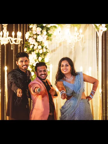 My signature pose with a happy couple after their Sangeet. It's all about creating fun, shareable moments.