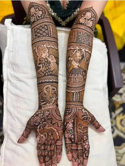 This design features portraits of a divine couple on the upper arms and the bride and groom's names on the palms, a beautiful blend of the sacred and personal.