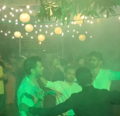 Smoke and green lights add a touch of party magic to the elegant wedding reception.