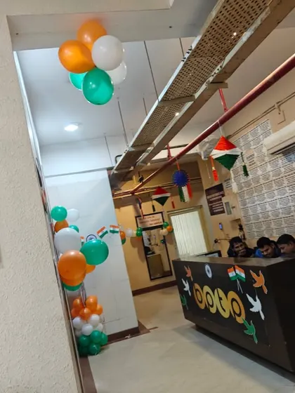 An office reception area decorated for Republic Day with simple tricolor balloon clusters and small flag details. Even a small setup can bring a lot of festive spirit to the workplace.