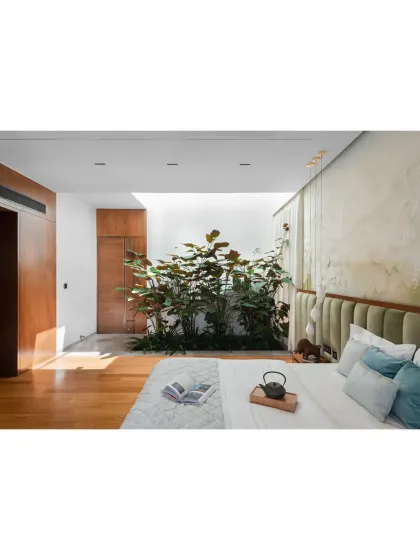 A bedroom designed around a private, open-to-sky courtyard. This feature allows natural light to flood the room while maintaining complete privacy, creating a serene personal sanctuary that feels connected to the outdoors.