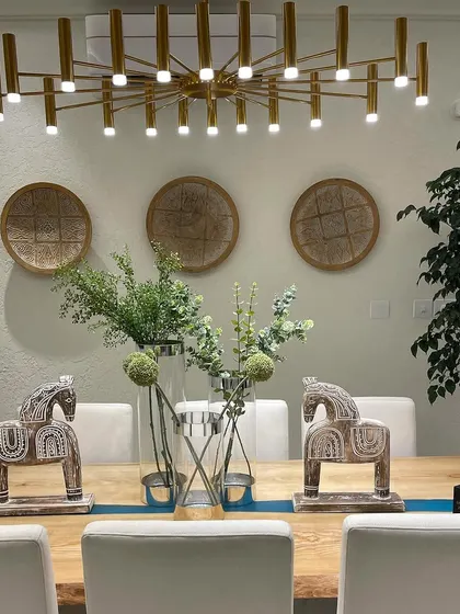 An elegant dining space designed for both comfort and style. Details like the modern chandelier and tasteful decor are what make a house feel like a high end home.