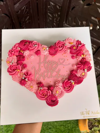 A heart-shaped cake with beautifully piped buttercream rosettes in shades of pink. It's a simple yet stunning way to say "I love you" or "Happy Birthday."