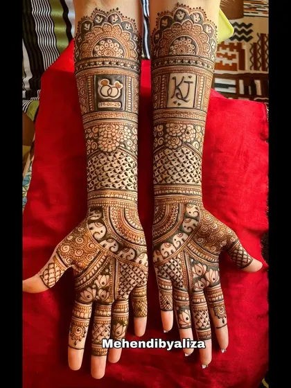 A beautiful engagement henna design with the couple's initials and engagement rings motif. The patterns are a lovely mix of traditional and modern styles.
