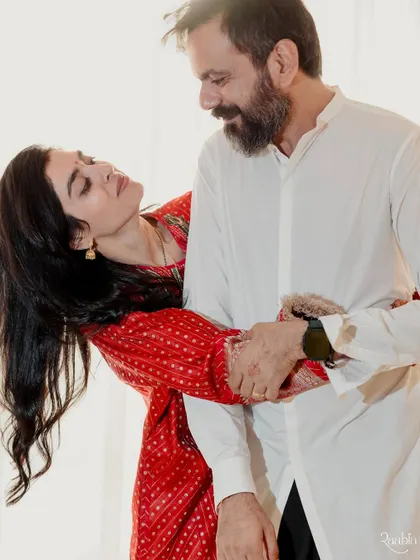 A candid, loving moment between the couple, full of movement and affection, beautifully captured in their new home.