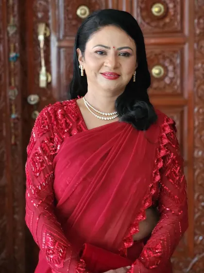 A happy and confident smile. The makeup is designed to enhance her natural beauty, creating a look that is both glamorous and graceful.