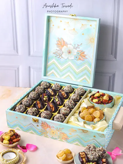 A luxurious two-tiered Diwali hamper box filled with dates and nuts, perfect for a high-end gifting campaign.