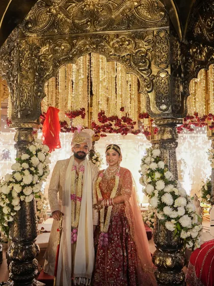 Another portrait of the couple inside the Khimsar mandap. The cascading floral strings and warm lighting created a perfect, intimate space for their vows.