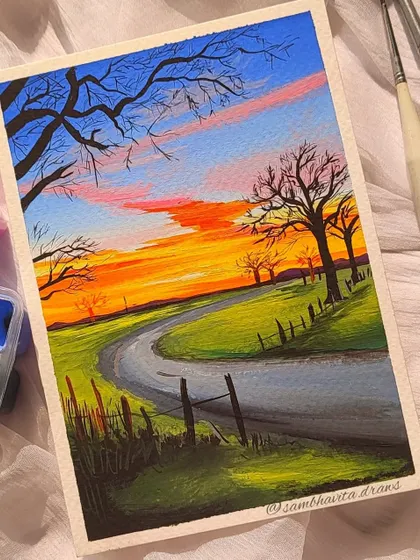 A close-up shot of my sunset landscape painting. You can see the brush strokes and the way the colors blend in the sky.