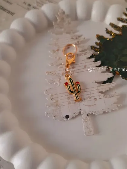A quirky cactus charm, perfect for a non-traditional Christmas gift. It's a fun way to say your love is sharp but sweet.