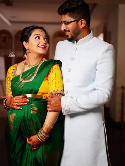 A classic portrait of the expecting couple. The coordinated traditional attire and the gentle way they hold the baby bump make this a perfect memory.